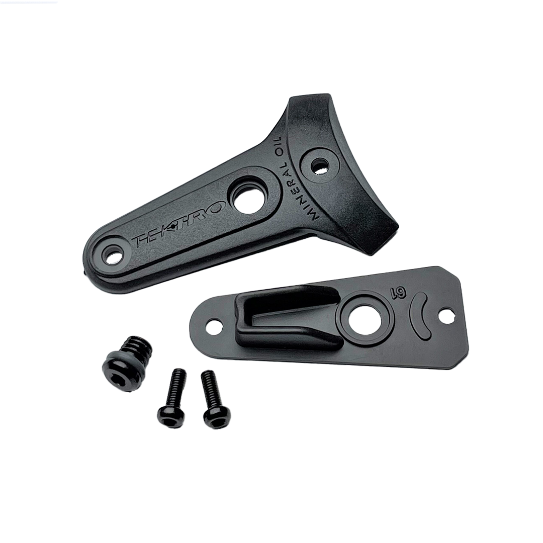 Two black TEKTRO metal brackets with screws on a white background